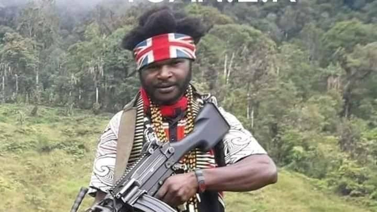 A young armed Papuan man with a headband, a widely circulated photograph