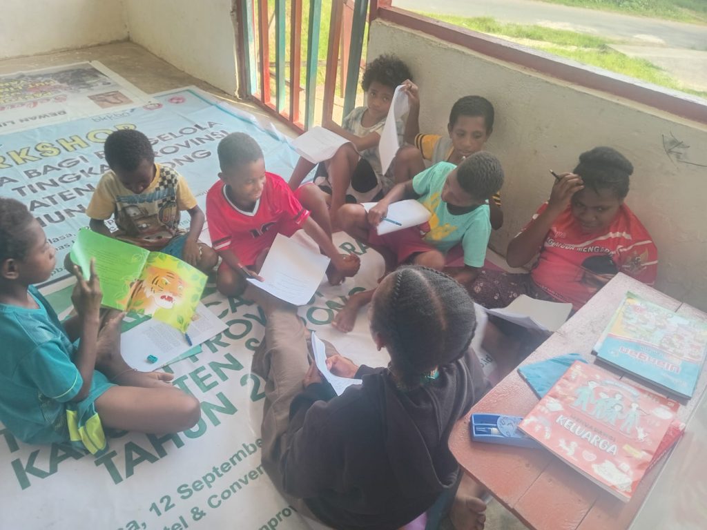 Children study inside a room at a displacement site